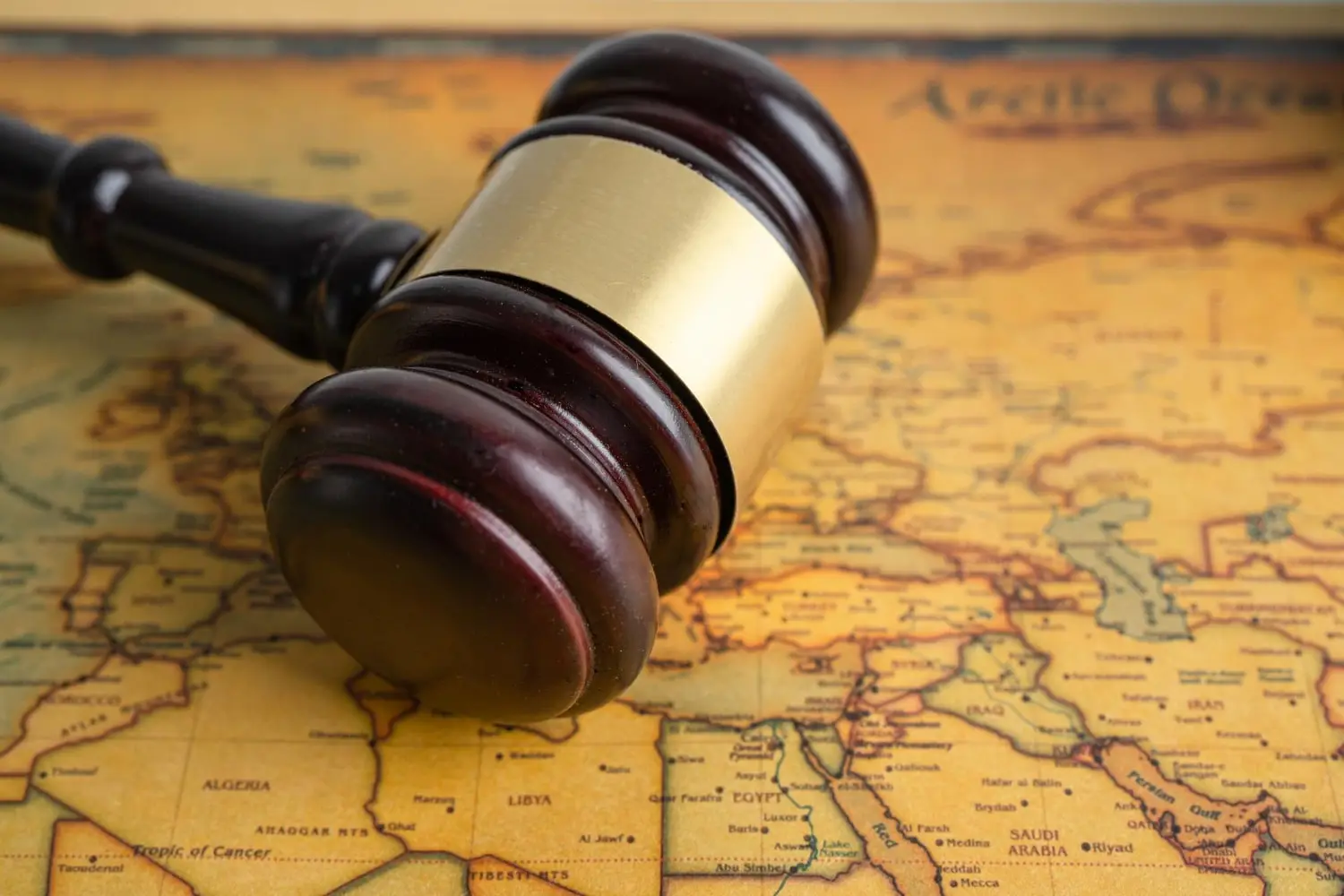 Judges gavel on a world map as a symbol of international comemrcial debt laws