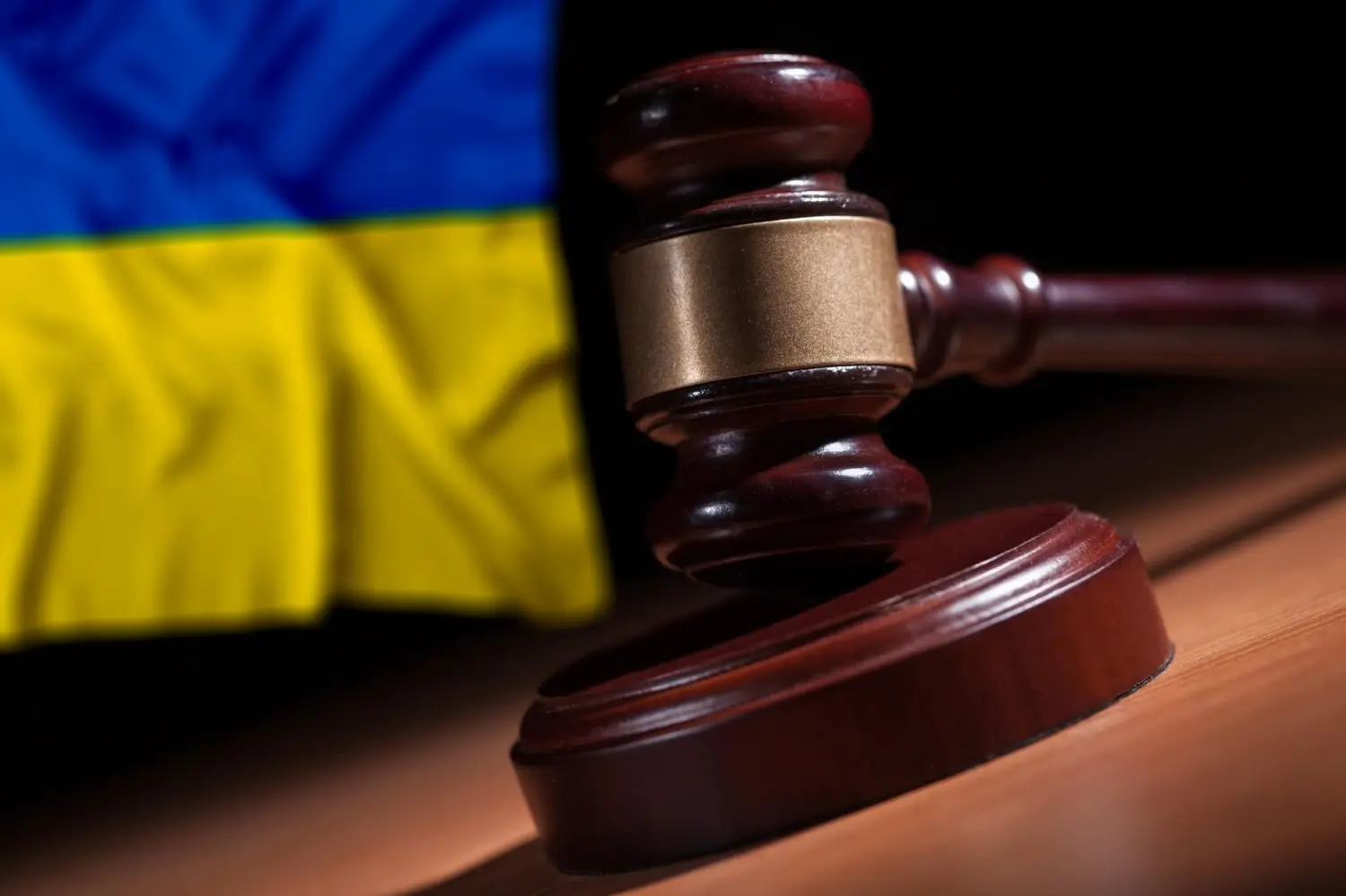 Judges law gavel in front of Ukrains flag